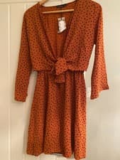 Image of boohoo wrap dress in orange and black polkadot, front tie detailing.size 8