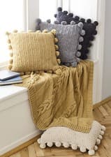 Image of King Cole Aran Knitting Pattern Cable Knit Throw & Pom Pom Cushion Covers 5661