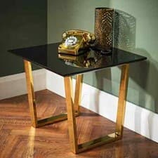 Image of Antibes Lamp Table Sleek, black, high gloss top rests on gold openwork legs