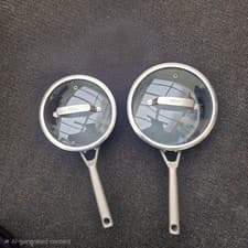 Image of 2 Ninja 20 and 18 Cm Foodi ZEROSTICK saucepans with glass lids.