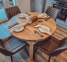Image of Solid Oak Round Dining Table With Wooden Legs and Leather Chairs