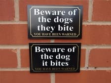 Image of BEWARE OF THE DOG IT BITES OR DOGS THEY BITE YOU HAVE BEEN WARNED sign / sticker