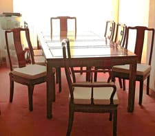 Image of Extending Dining Table with 8 chairs and protective cover. 2 separate Leaves.