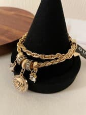 Image of Guess Gold Tone Multi Charms Adjustable Chain Bracelet with original dust bag