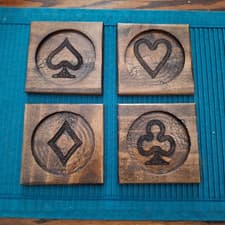 Image of Carved wood drink coasters, Playing Card suits, 4.5" sq with 3.5" dia for drink