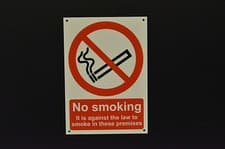 Image of NO SMOKING IT IS AGAINST THE LAW TO SMOKE IN THESE PREMISES sign or sticker