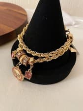 Image of Guess Gold Tone Multi Charms Adjustable Chain Bracelet, dust bag included