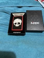 Image of New collectible Zippo featuring a red matte finish and a white skull graphic