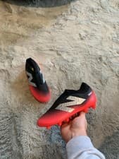 Image of New balance kids tekela v4+ red and black FG football boots