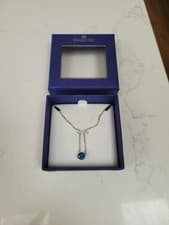 Image of swarovski necklace with blue gem stone. brand new, still in box, never worn.
