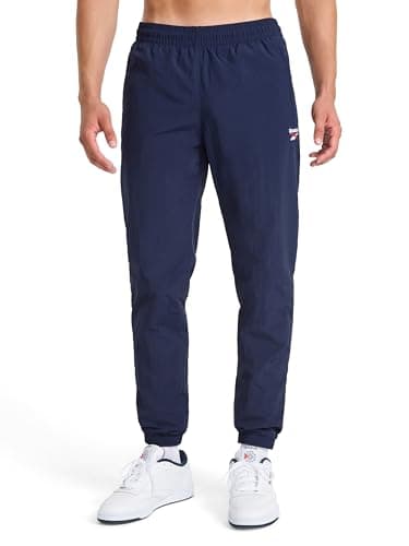 Image of Reebok Apparel Men's Track Pant, Standard Fit, 31” Inseam, Lightweight Nylon Fabric, Vector Navy, Medium