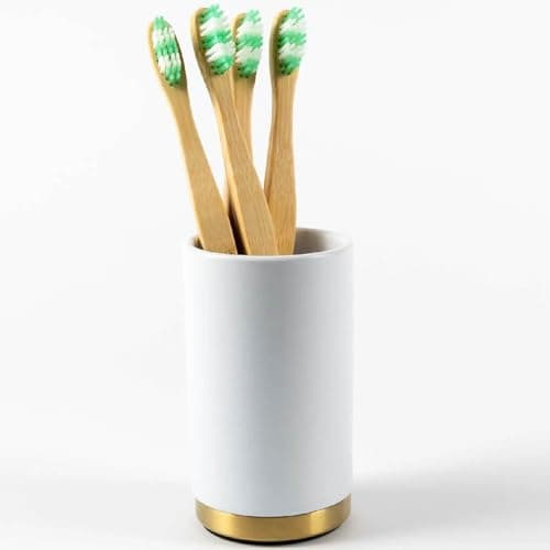 Image of Pebble Grey™ Elemental Ceramic Toothbrush Holder for Bathrooms, Round Toothbrush Cup, Padded Bottom, Freestanding (Brushed Brass)