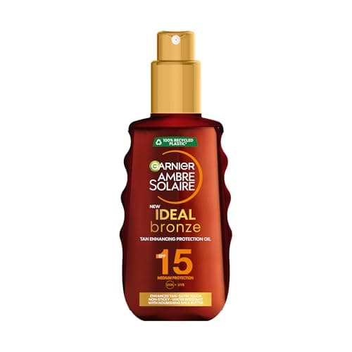 Image of Garnier Ambre Solaire Sun Cream Spray SPF15, Ideal Bronze Protective Oil Sunscreen, Tan Enhancing, High Sun Protection Factor 15, Shea Butter, Water Resistant, Non-Greasy, UVA & UVB Protect150ml