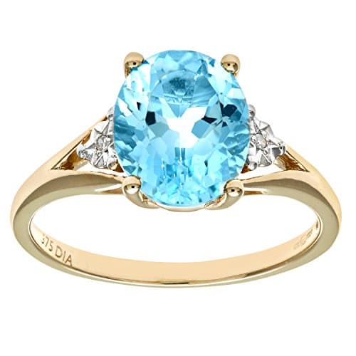 Image of Naava Women's 9 ct Yellow Gold Round Brilliant Cut Oval Blue Topaz and Diamond Ring, Size M