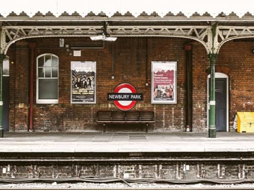 Image of AOFOTO 7x5ft Train Station Backdrop Railway Platform Old Brick Wall Nostalgic Playbill Bench Photography Background Locomotive Track City Buildings Portrait Photoshoot Studio Props Vinyl Wallpaper