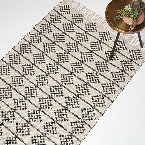 Image of HOMESCAPES Handwoven Black & Natural Rug with Tassels 90 x 150 cm 100% Cotton Adana Geometric Pattern Rug for Living Room Hallway or Bedroom