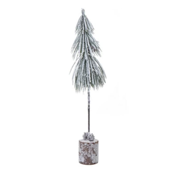 Image of Small Snowy Tree In Wood Log