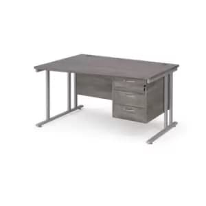 Image of Maestro 25 left hand wave desk 1400mm wide with 3 drawer pedestal - silver cantilever leg frame and grey oak top