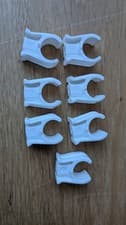 Image of 7 x pack of white pipe clips 15mm