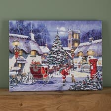 Image of 40 x 30cm Battery Operated Fibre Optic Santa and Village Christmas Wall Canvas