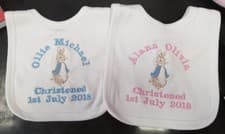 Image of Personalised Peter Rabbit bib pink blue white embroidered with name & date